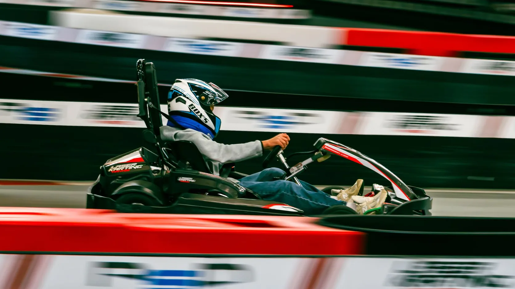 Indoor go-kart on a barrier-lined electric circuit