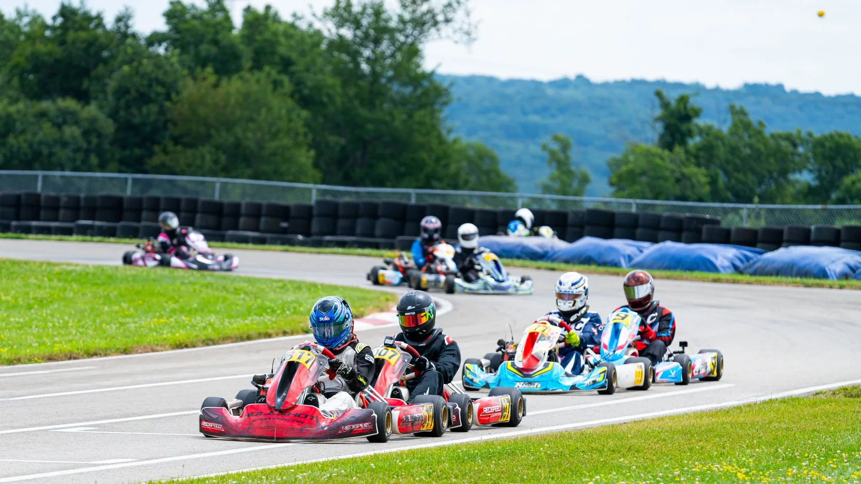Go-kart racers on an outdoor circuit — licensed stock photo used to illustrate Bangalore karting